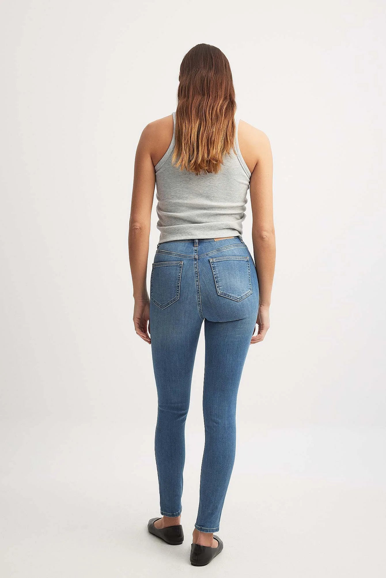 Back View of Mid Blue Skinny High Waist Destroyed Jeans – Back view highlighting the design and fit of the jeans.